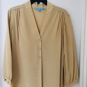 Tan silk blouse.